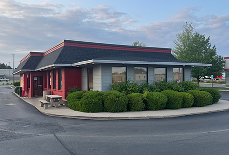 Red restaurant building with outdoor seating